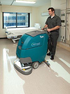 Tennant T300 Walk-Behind Floor Scrubber cleaning a patient room in a hospital