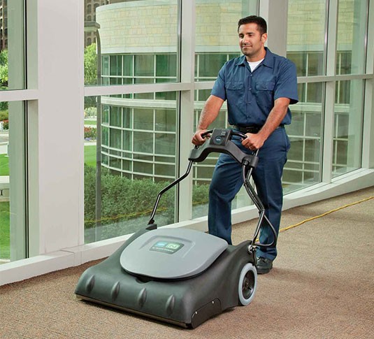 Custodian vacuuming a school with the V-WA-30 Wide Area Vacuum.