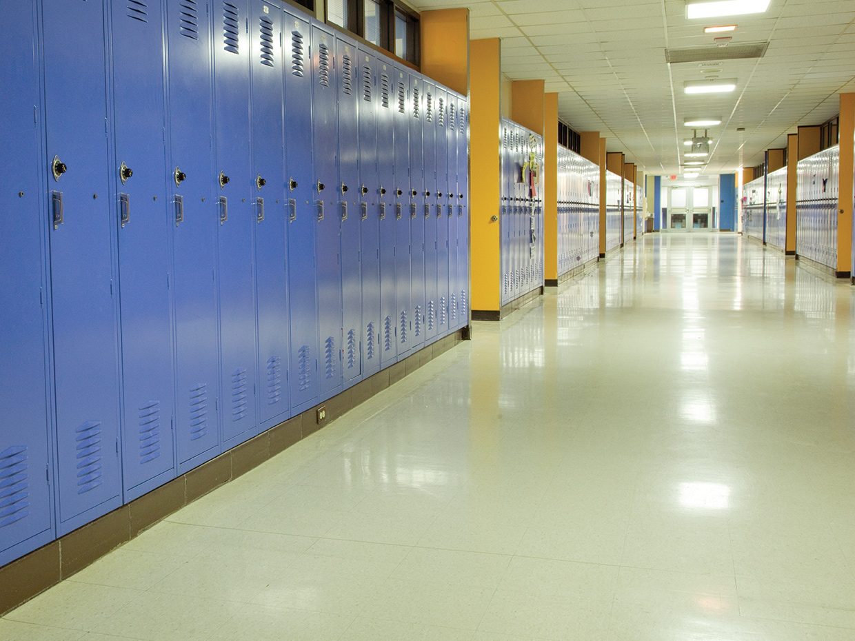 Newly restored floors welcome students in a school hallway